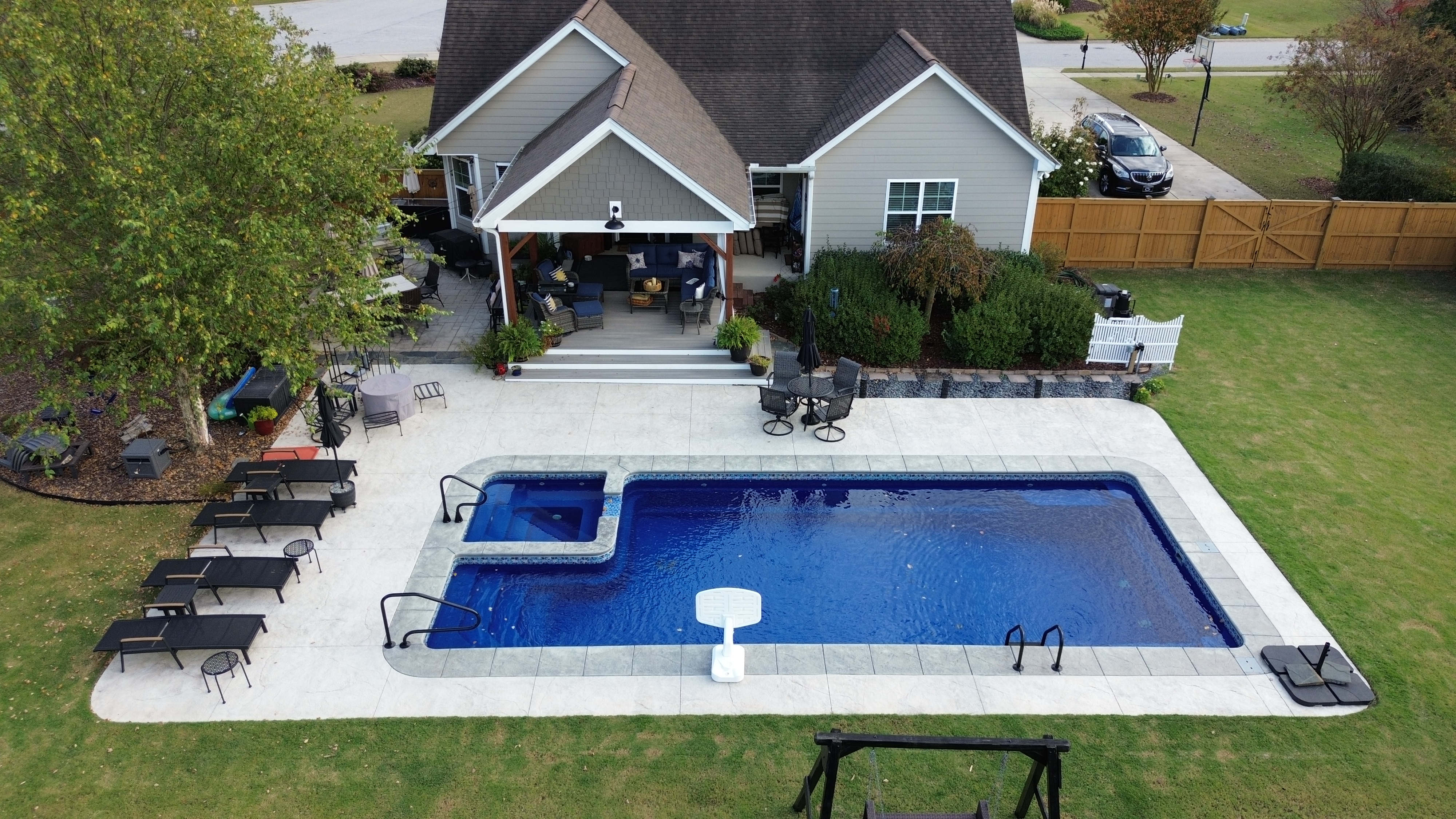 Aerial view of beautiful outdoor living space with pool and custom structures